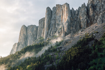 Bolshoy Tkhach mountain with rocks, fog and sunlight. Caucasus Mountains.