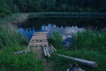 Fototapeta premium wooden footbridge on pond bank