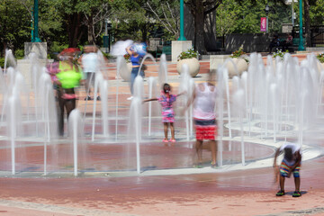 Motion blur several kids playing in Centennial Olympic Park fountain