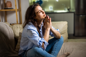 Depressed Young Woman Sitting Alone in Her Living Room