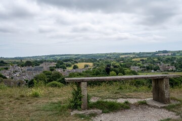 bench overlooking  St Edwards the parish church at the heart of the village of Corfe Castle Dorset...