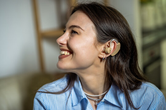 Happy Young Deaf Woman Wearing Hearing Aid