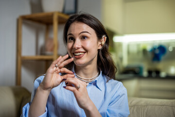 Happy Young Deaf Woman Using Sign Language with Hearing Aid