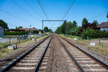Perspective view over double railway track at the Flemish countryside in Heist Op Den Berg, Antwerp Province, Belgium