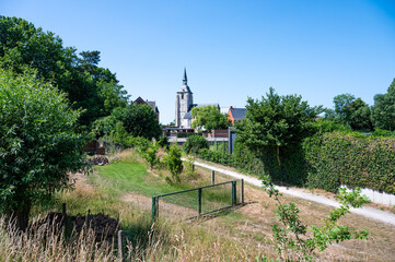 Landscape view over the Saint MArtin church and green zone around the river Dyle in Rijmenam, Bonheiden, Flemish Brabant, Belgium
