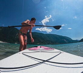 Tourist ready for an excursion in the lake of Molveno, in Trentino, in Northern Italy, on a stand...