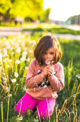 Floating dandelion seeds, child blowing softly out-of-focus. Ethereal summer scene, pink leggings, dreamy bokeh backdrop
