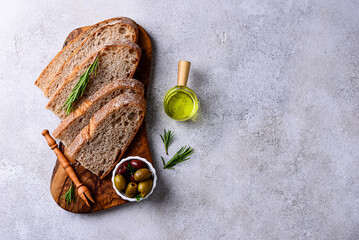 Fresh bread, olive oil and mix of olives.