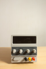 Fototapeta premium digital DC power supply unit wooden table