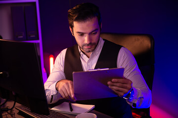 Stressful smart businessman analyzing market data on paper work report folder to create sales...