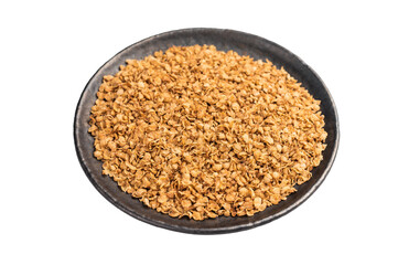 Dry buckwheat flakes in a plate  isolated on white background. top view