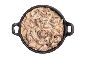Mushroom beef stroganoff in a skillet isolated on white background. top view