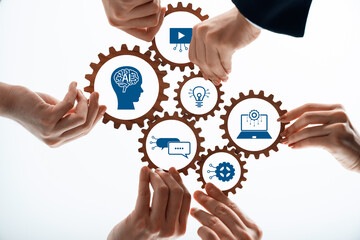 Collaborative hands hold gears symbolizing AI, innovation, and multimedia concepts. The imagery...