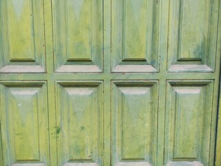 The green door has a lot of dirt on it