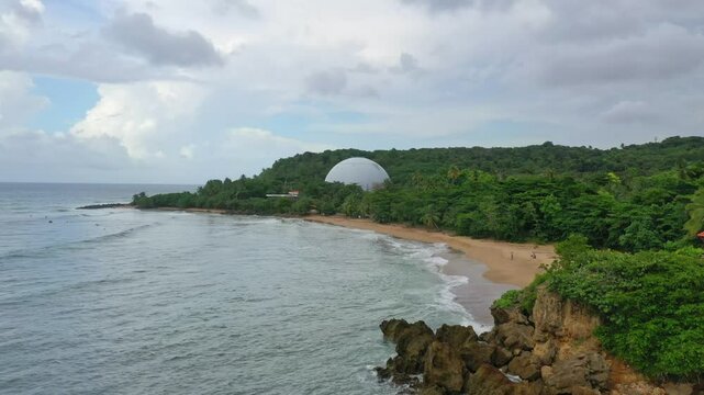 Serene coastal view of Domes Beach in Rincon, Puerto Rico, with lush greenery and the dome structure