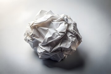 Crumpled white paper ball isolated on white background with shadows