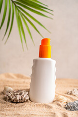 Sunblock or sunscreen in cosmetic tube on beach sand and beige background. Summer vacation and skin care concept with starfish and sea shells, spf uv-protect cosmetics. Skin health. High quality photo