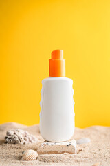Sunblock or sunscreen in cosmetic tube on beach sand and beige background. Summer vacation and skin care concept with starfish and sea shells, spf uv-protect cosmetics. Skin health. High quality photo