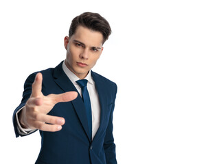 elegant young businessman making a hand gesture to the camera