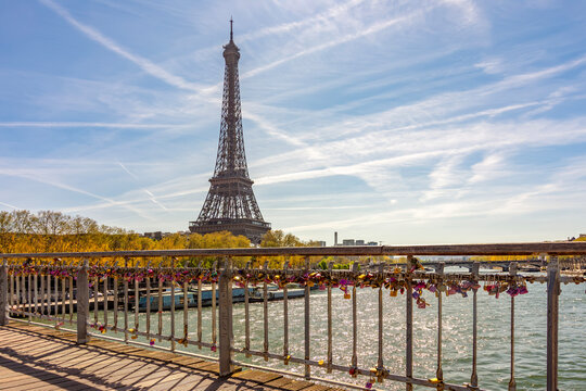 Eiffel tower and tourist locks on Debilly bridge over Seine river, Paris, France