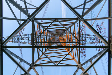 Detailed shot of an industrial power tower’s steel lattice patterns, illustrating structural...