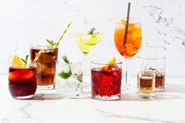 Alcohol cocktail drinks at white background.