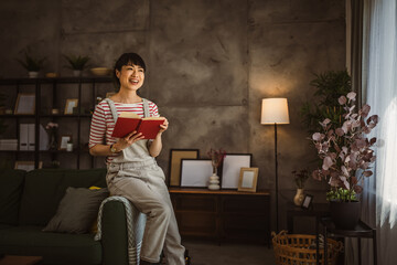 one female mature japanese woman read book at home