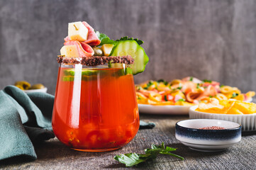 Cocktail and snack in one serving in a glass on the table