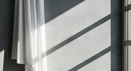 Obraz premium Soft White Curtain Draped Against Gray Wall with Diagonal Sunlight Creating Artistic Shadows in Minimalist Interior Space