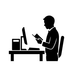 Silhouette of man reading a book while working on computer at desk  
