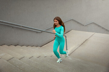 Shot of fitness woman running up on steps. Female runner athlete going up stairs.