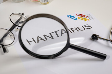 Hantavirus Alert Paper with Magnifying Glass on Doctor’s Desk – Medical Surveillance Scene