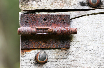 Rusty latch on an old wooden door