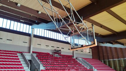 Empty sports hall ready for competitions and championships. Sports basketball hall with red seats. Sports atmosphere, preparation for sports events - Powered by Adobe