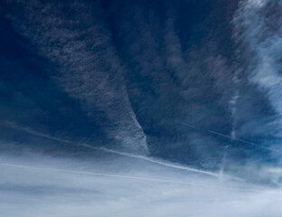 The bright blue sky is calm and peaceful, with a few white clouds drifting gently