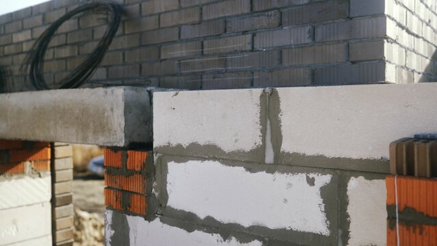 Construction site showing concrete lintel over brick wall opening