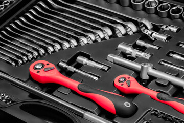 Fototapeta premium A toolbox with many different tools including pliers, wrenches, and screwdrivers. The tools are organized in a way that makes it easy to find what you need