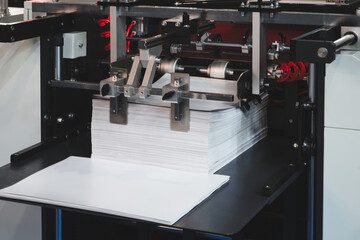 Elements of corton boxes are collected in stack. Conveyor line for the production of boxes. Machine...