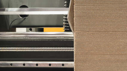 Elements of corton boxes are collected in stack. Conveyor line for the production of boxes. Machine...