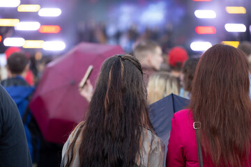 A concert on the street in the city with a large number of people.
