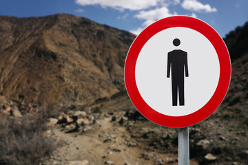 Trail closed warning sign. Prohibition of walking on mountain path. No entry for hikers in rocky...