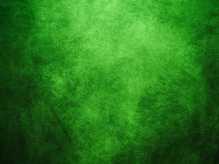 Pained cloth or canvas background. Surface of a textile with random shape and color. Design background. Irish green and black background.