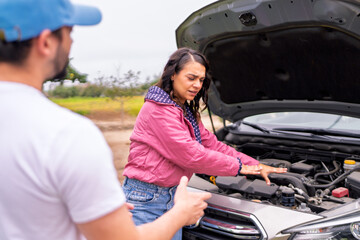 Roadside assistance, mechanic helping woman with car trouble