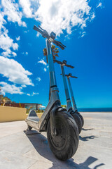 Electric Scooters Parked by the Ocean, Eco Urban Transport Concept