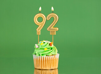 Number 92 birthday candle - Cupcake on a green background