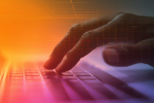 Digital hand typing on laptop keyboard with futuristic data interface