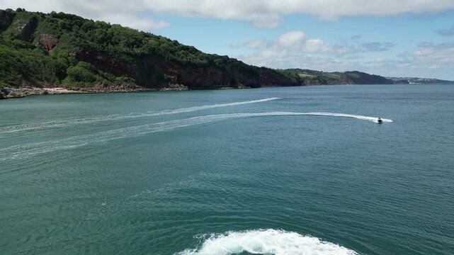 Babbacombe, South Devon, England: DRONE VIEWS: Jet skiers entertain themselves in Babbacombe bay. Babbacombe and Torbay are popular UK holiday destinations (Clip 2 of 5).