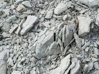 Close-up of fractured chalky marl rock surface. Textured limestone with visible cracks, ideal for...