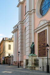 St Nicholas Cathedral facade with statue and plaque in Stockholm