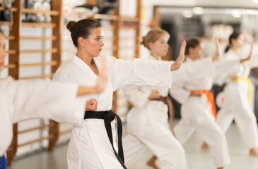 Kata karate teacher conducts classes and performs movements and fighting techniques together with...